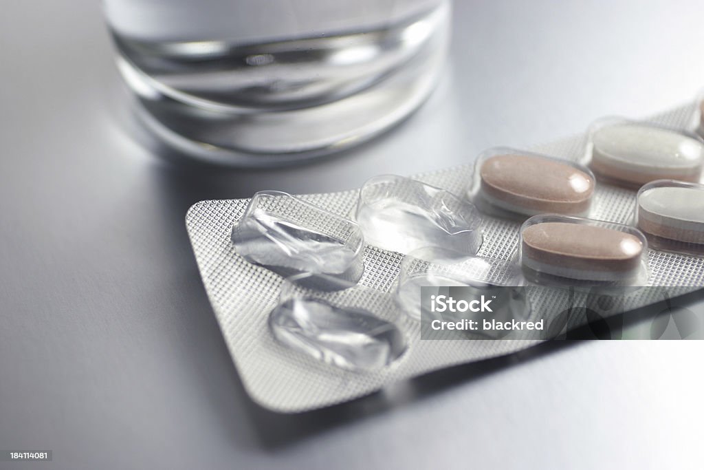 Healthcare Close up of pills and a glass of water on table.Similar images - Addiction Stock Photo