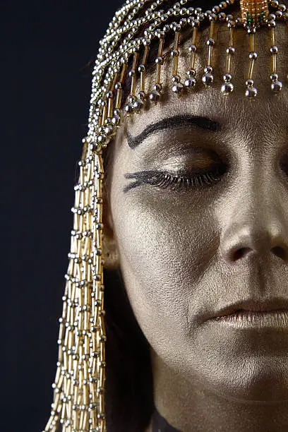 Cleopatra type woman with eyes closed.