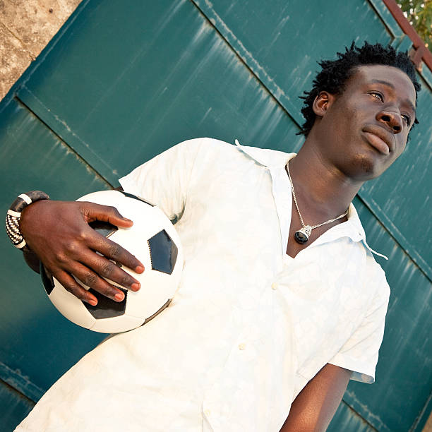 istock African Man Holding A Soccer Ball 184114278