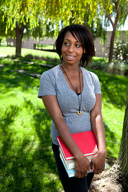 istock Pretty Young Student in Park with Books 184114700