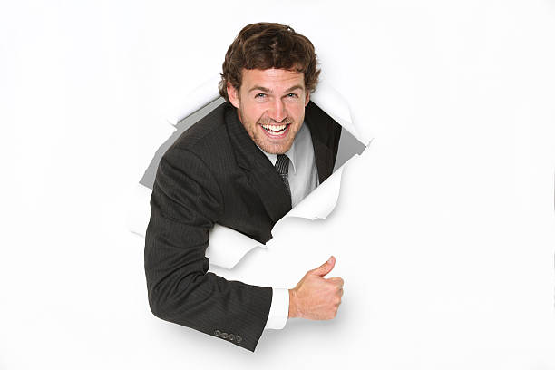 istock Businessman emerging through a hole in white paper 184115007