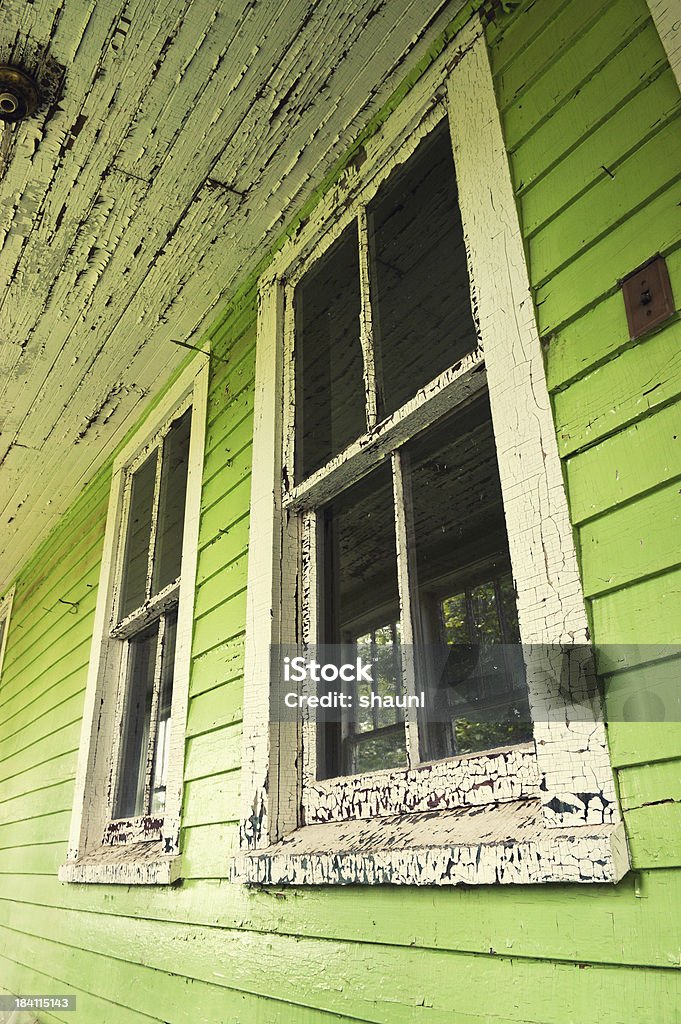 Green Windows Front porch windows of an abandoned home. Architectural Feature Stock Photo