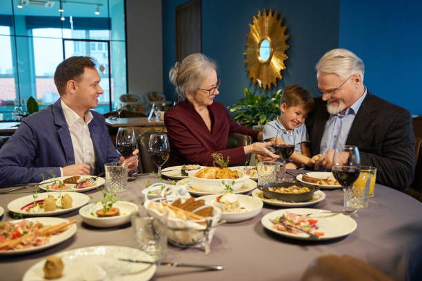 istock Happy family having festive dinner and celebrating Hanukkah at dining table 1841163411