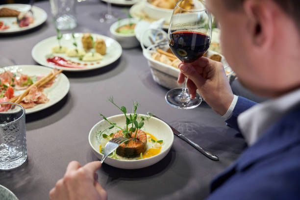 istock Unrecognizable man holding glass of wine having dinner in restaurant 1841163422