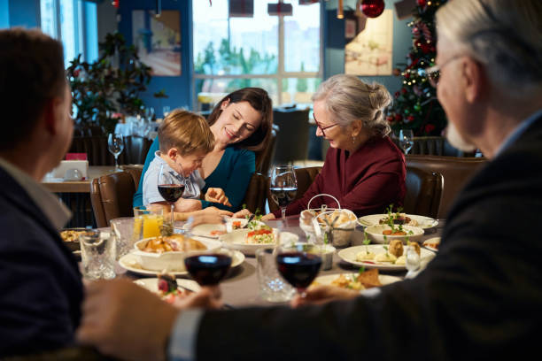 istock Aged woman enjoying communicating with little boy during New Year celebration 1841163953