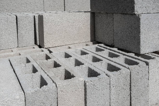 istock Stack on Pallet of Concrete Cinder Blocks, Grey Uniformed brick Shapes building material. New for use on construction site 1841165045