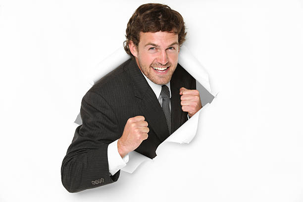 istock Businessman emerging through a hole in paper 184116527