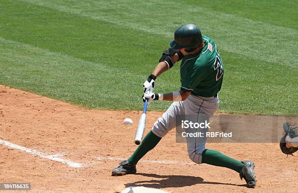 Baseball Batter In Green Uniform Hitting Ball Stock Photo - Download Image Now - Baseball - Sport, Baseball - Ball, Baseball Player