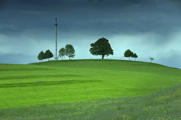 Photo of Mobile phone antennae on a green field