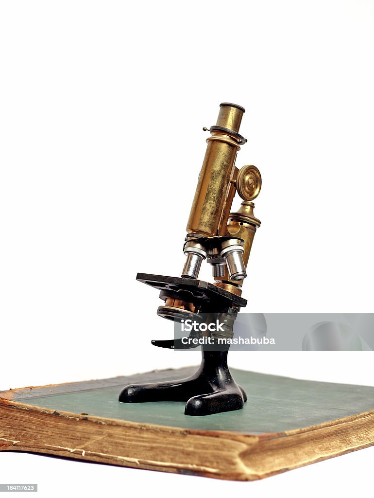 Microscope on the book Ancient microscope on the antiquarian book Analyzing Stock Photo