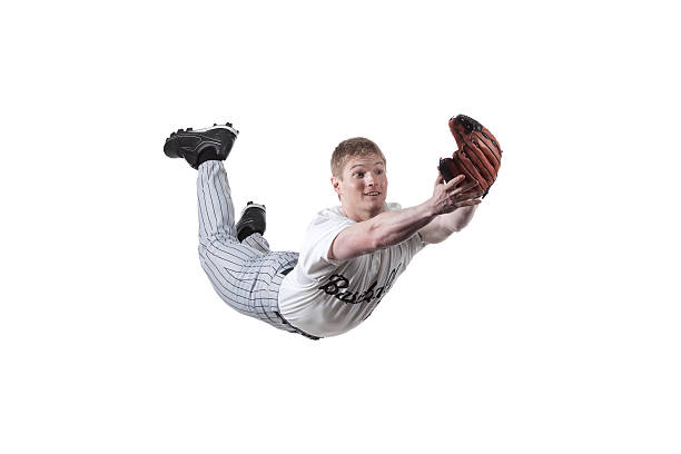 Baseball player diving to catch the ball