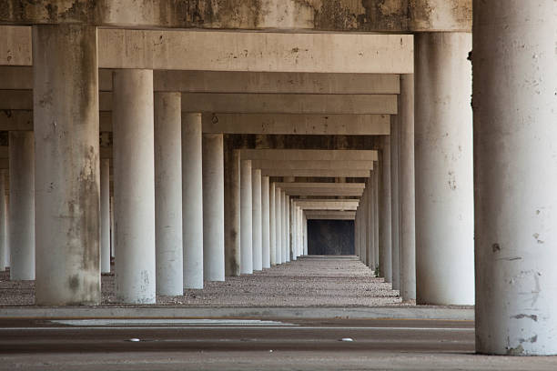 istock Concrete columns of elevated freeway create a tunnel perspective 184118139