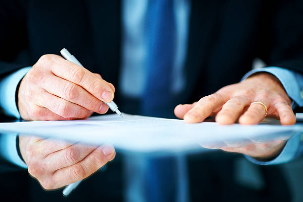 istock Business man hands signing on document at his desk 184118552