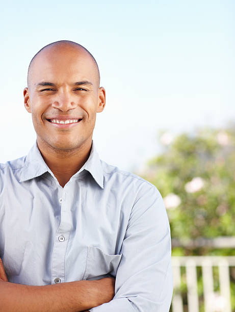 istock Happy young man with hands folded outdoors 184118569