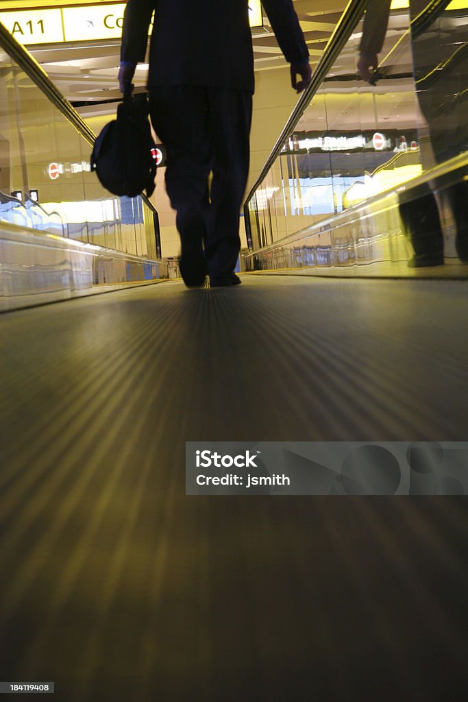 Business travel 3 Business travleing man walks on people mover with blurred forground Airport Stock Photo