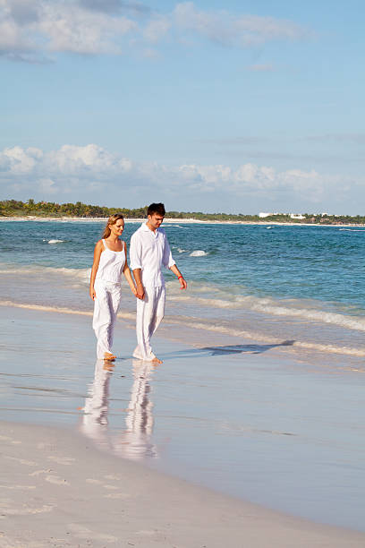 istock Romantic couple in love walking along a beach 184119677