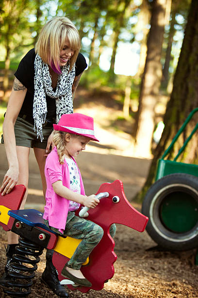 istock Playful Mom and Daughter Having Fun on Playground 184121512