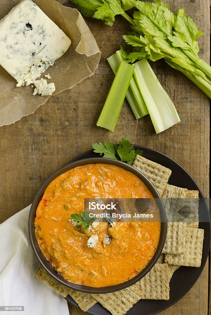 Buffalo Chicken Wing Dip from Above "Spicy Buffalo Chicken Wing Dip, made with chicken, blue cheese, cheddar cheese, hot sauce and celery.  Shot from directly above on a rustic wooden crate.Similar Images:" Dipping Sauce Stock Photo