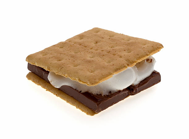 S'Mores: Marshmallow Summertime Treat (Isolated) A s'more - the classic camping dessert treat - melted marshmallow and chocolate sandwiched between graham crackers. White background. (Shot on a light table.) smore photos stock pictures, royalty-free photos & images