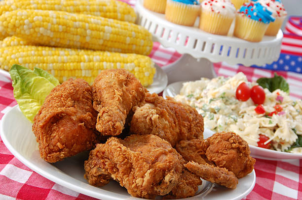Fourth of July Picnic with chicken, corn and cupcakes stock photo