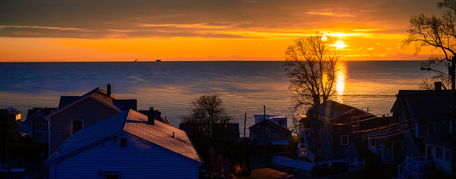 Sunrise ocean view over the rooftops of the beach houses in the seaside neighborhood in New England, USA