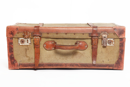 Old suitcase isolated on white background. Brown leather vintage suitcase with metal brackets on the corners and a lock. Baggage.