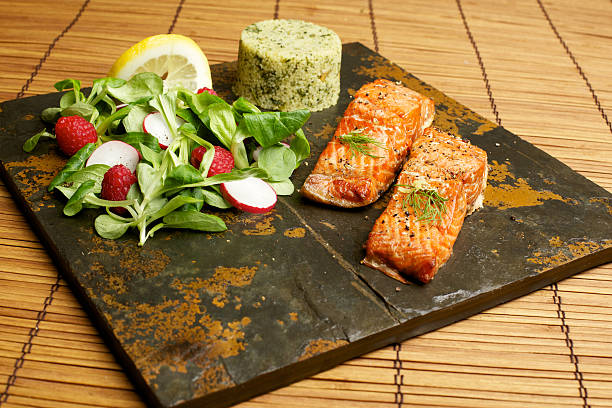 istock Slate tile plated grilled wild Salmon fillet arugula and couscous 184129389