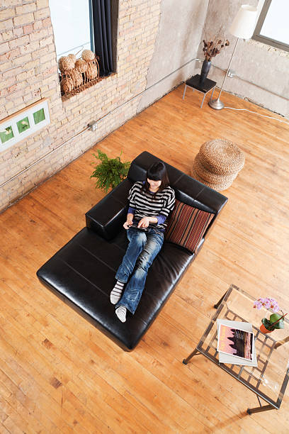 istock Asian Woman in Loft Condominium Apartment Home Using Tablet Computer 184129551