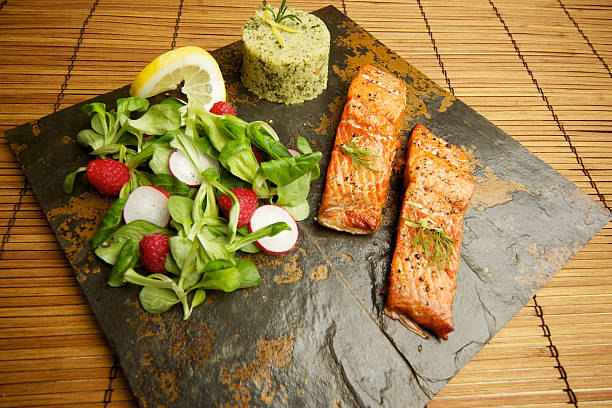 istock Slate tile plated grilled wild Salmon fillet arugula and couscous 184129552