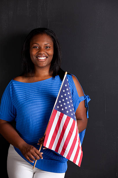 istock black female holds American flag 184129592