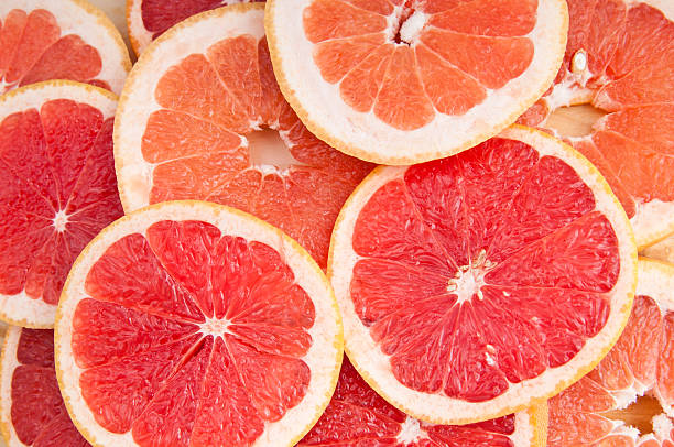 fresh grapefruit and slices fresh grapefruit and slices backgroundCheck my other fruid and vegetable backgrounds: grapefruit photos stock pictures, royalty-free photos & images