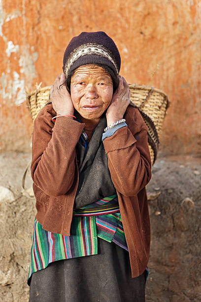 istock Tibetan woman carrying basket 184130028