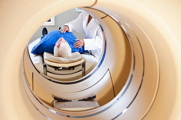 istock Radiologist preparing patient for PET-CT scanner 184130569