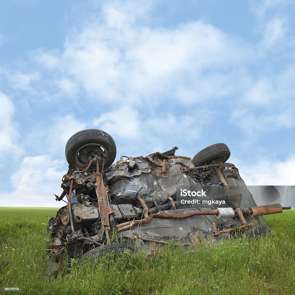 Overturned Car Crashed and overturned car abandoned after accident in the field. Abandoned Stock Photo