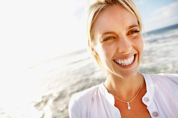 istock Cheerful young woman on the beach 184131554