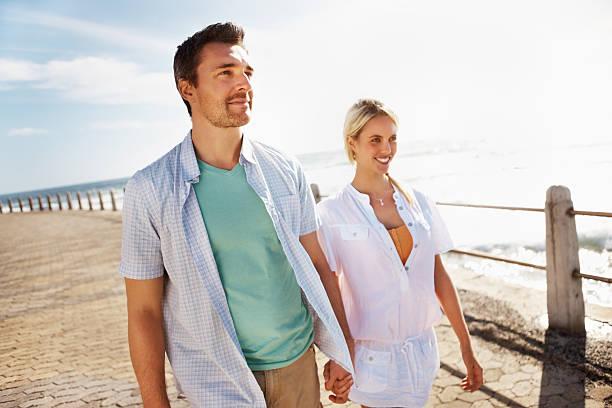 istock Beautiful couple strolling on a pier 184132774