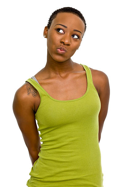 Young mixed race woman smiling, looking up, in front of a white background. Isolated on white.