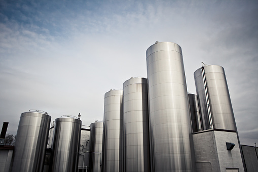 Stainless steel silos at a processing plant.