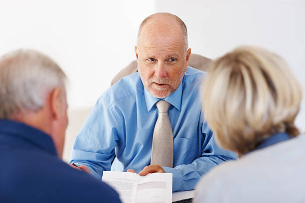 istock Successful financial planner talking to a couple 184135435
