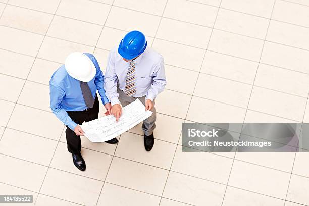 Professionals Looking Over Blueprints Stock Photo - Download Image Now - Directly Above, Hardhat, 30-39 Years