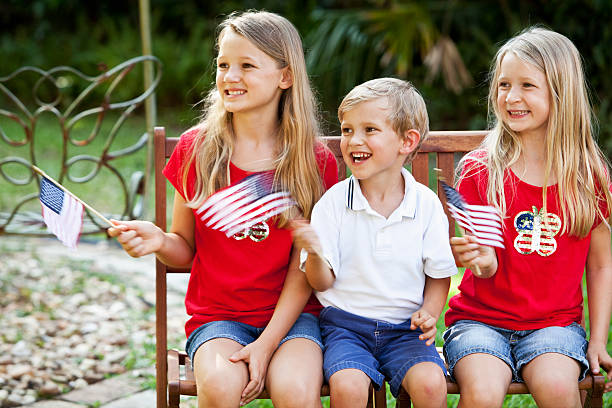 istock Children waving mini American flags 184135686
