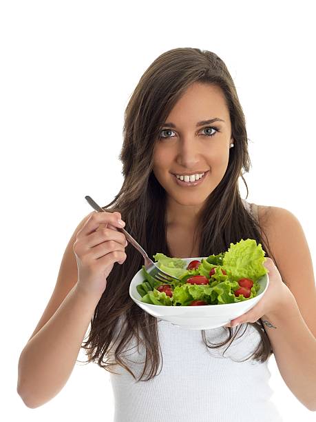 istock girl eating salad 184135692