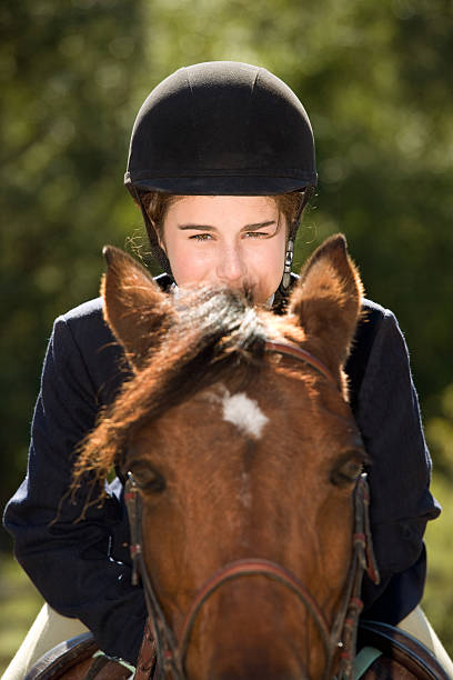 equestrian with her horse Equestrian teenage girl riding towards camera. horse jumping front stock pictures, royalty-free photos & images