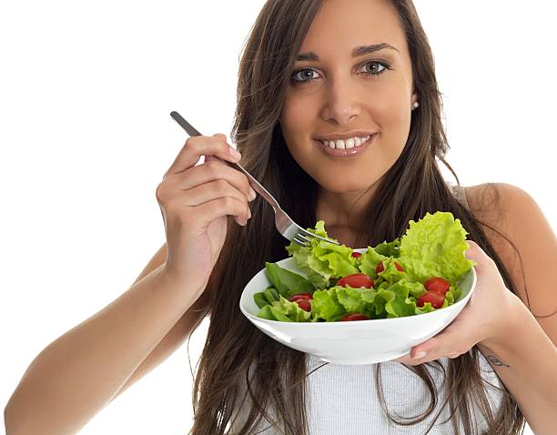 istock girl eating salad 184136058