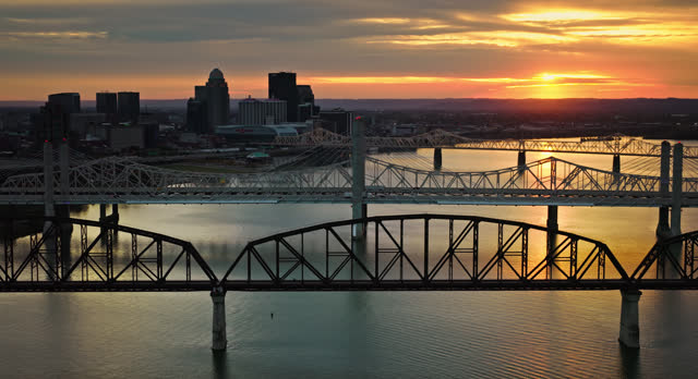 the Ohio River Flowing Past Downtown Louisville, Kentucky on a Fall Sunset - Aerial