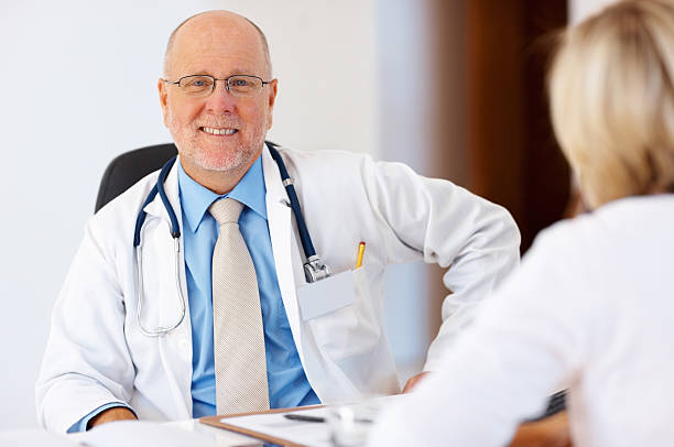 istock Doctor sitting in his clinic 184137461