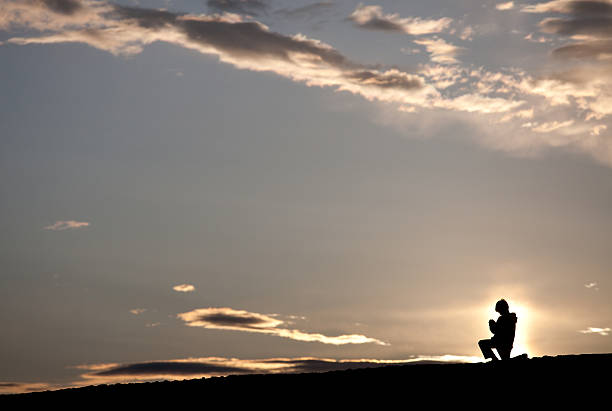 istock Silhouette of Young Boy Praying 184137669