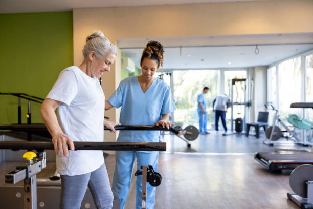 istock Senior woman in physical therapy walking on the bars 1841380043