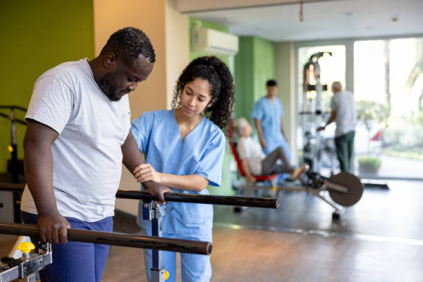 istock Man in physical therapy walking on the bars 1841380588