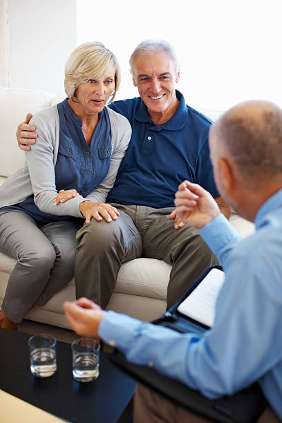 istock Senior couple talking to financial planner 184138628